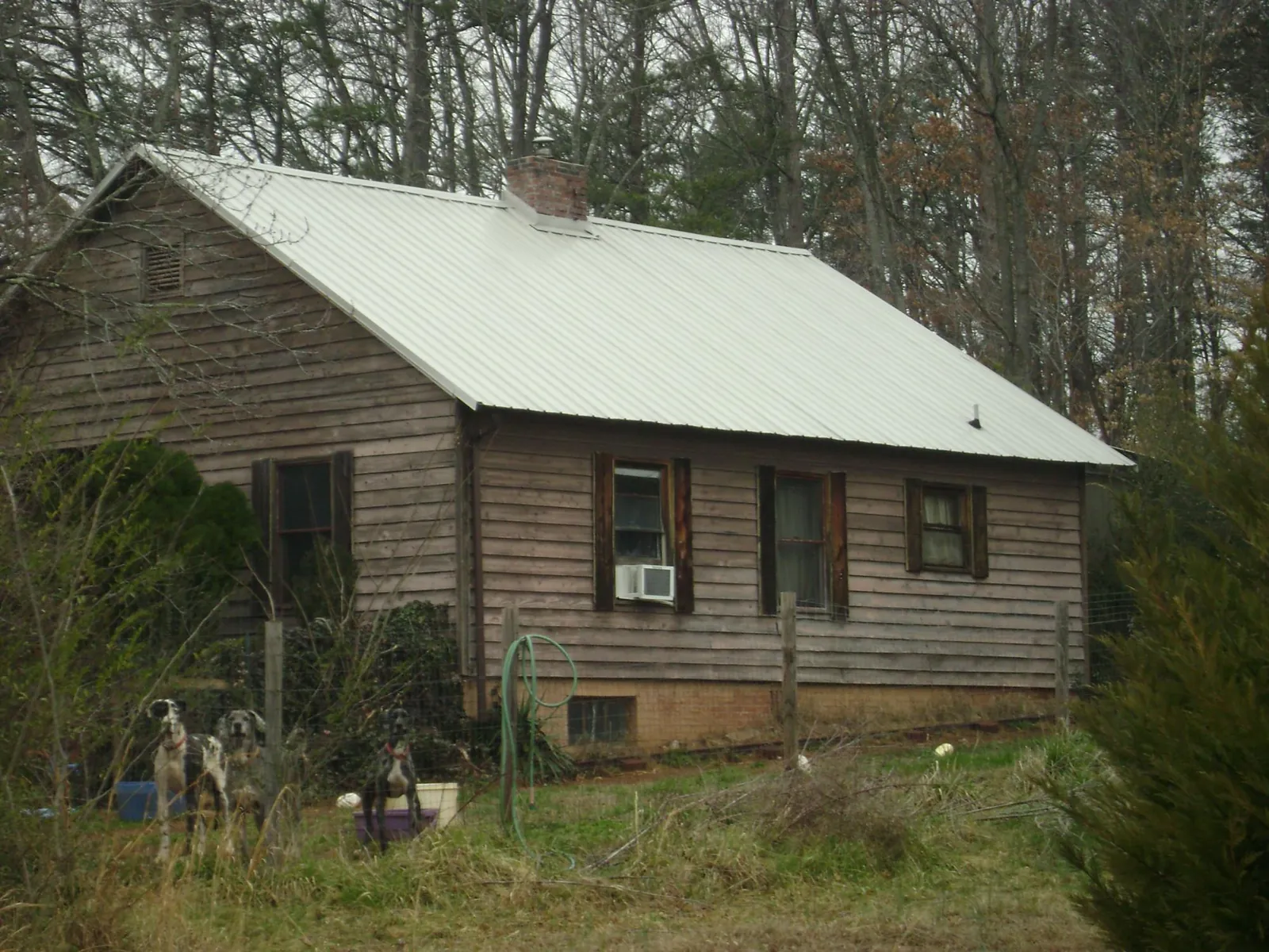 White metal roof on an old wood sided farmhouse, from a Metal Roof Installation job in Allenton